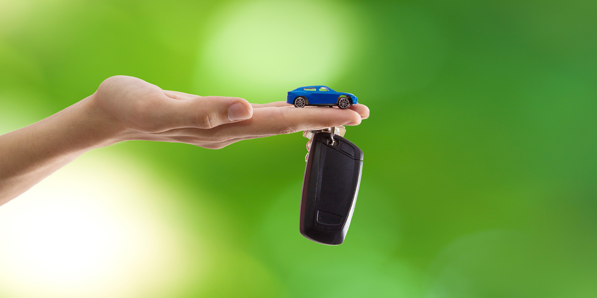 Car keys and a key fob in an open hand