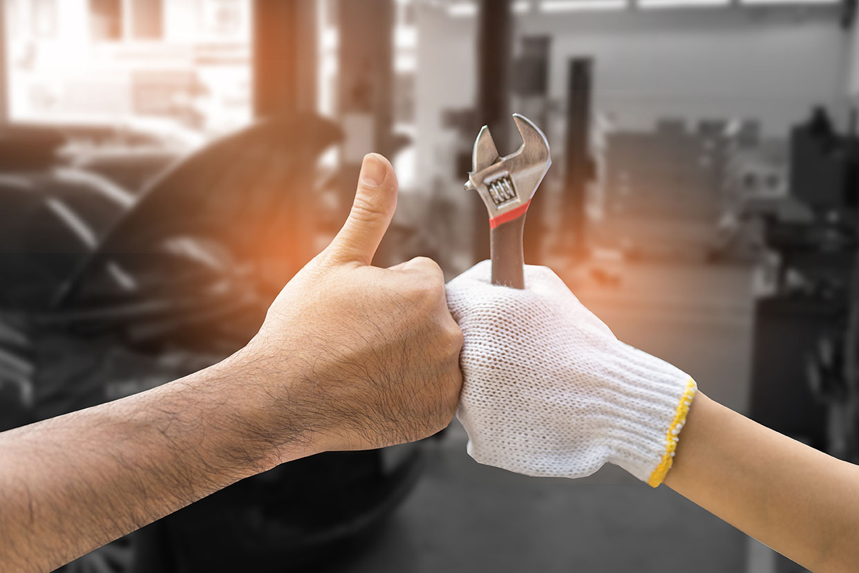 Thumbs up from two certified auto mechanics in their shop