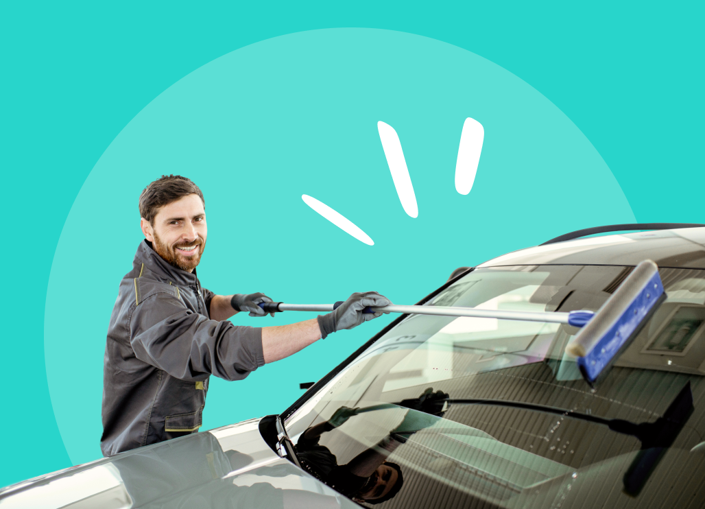 Car wash attendant washing a car